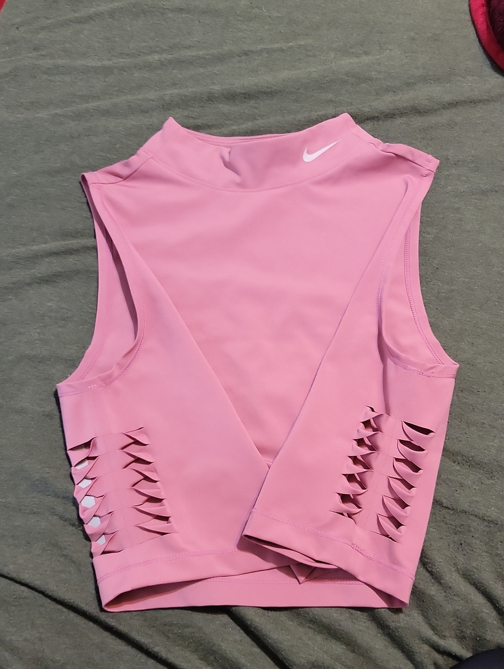 pink Nike Pro Dri-FIT crop top featuring distinctive side-cutout details